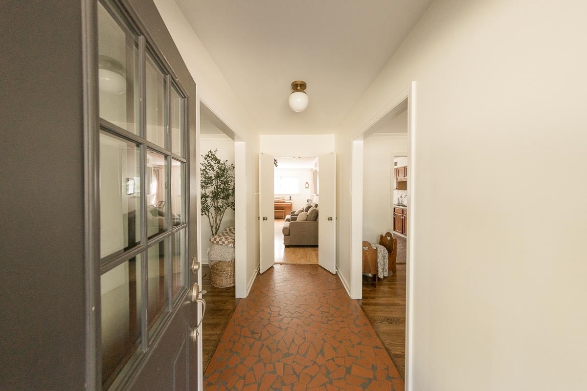 5431 Quince Road Memphis, TN 38119 - Photo 2 of 21 a view of a hallway with wooden floor and a living room