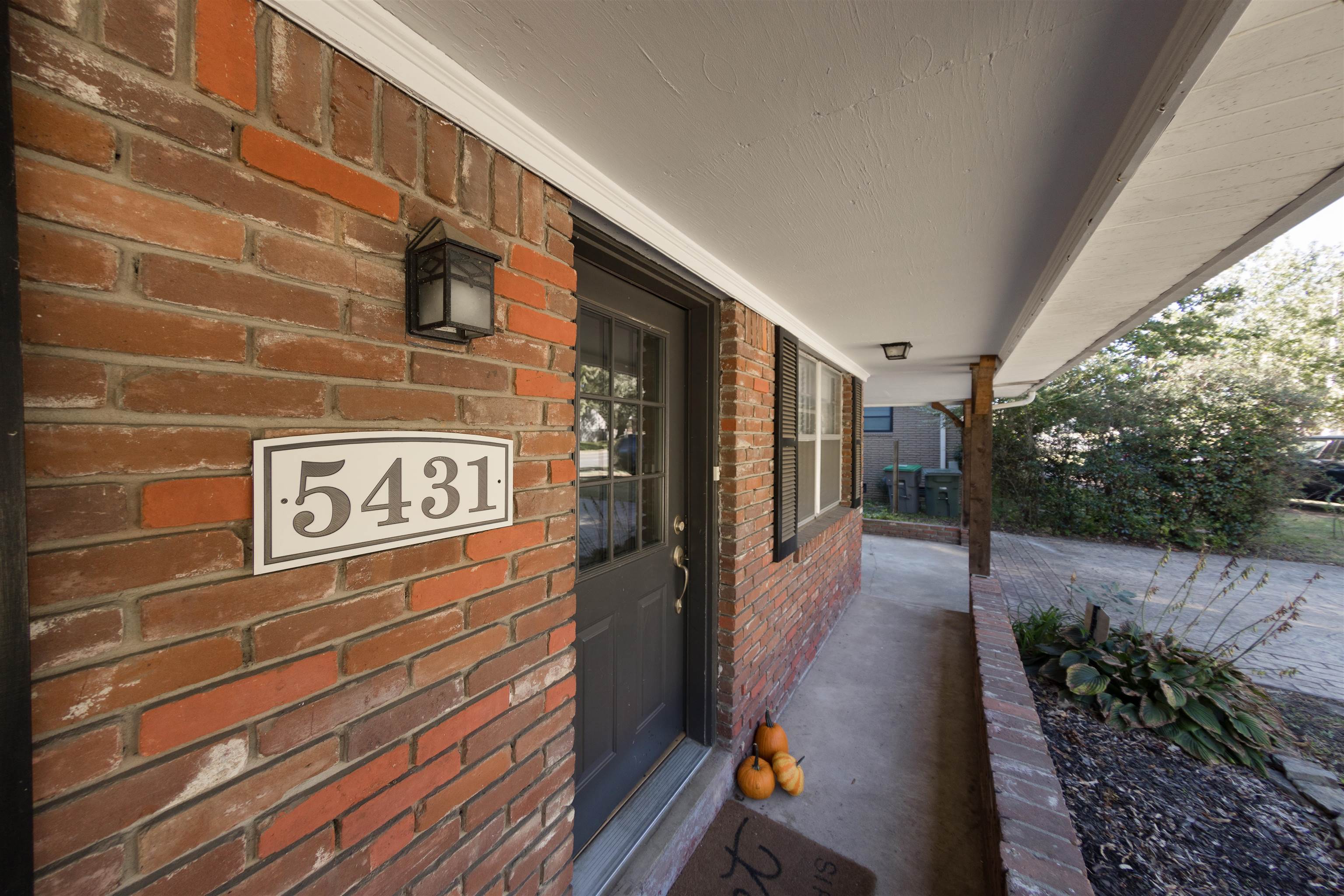 5431 Quince Road Memphis, TN 38119 - Photo 21 of 21 a view of a street with potted plants on brick wall