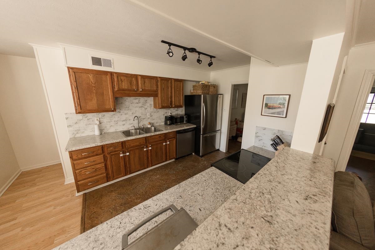 5431 Quince Road Memphis, TN 38119 - Photo 8 of 21 a kitchen with stainless steel appliances granite countertop a sink stove and refrigerator