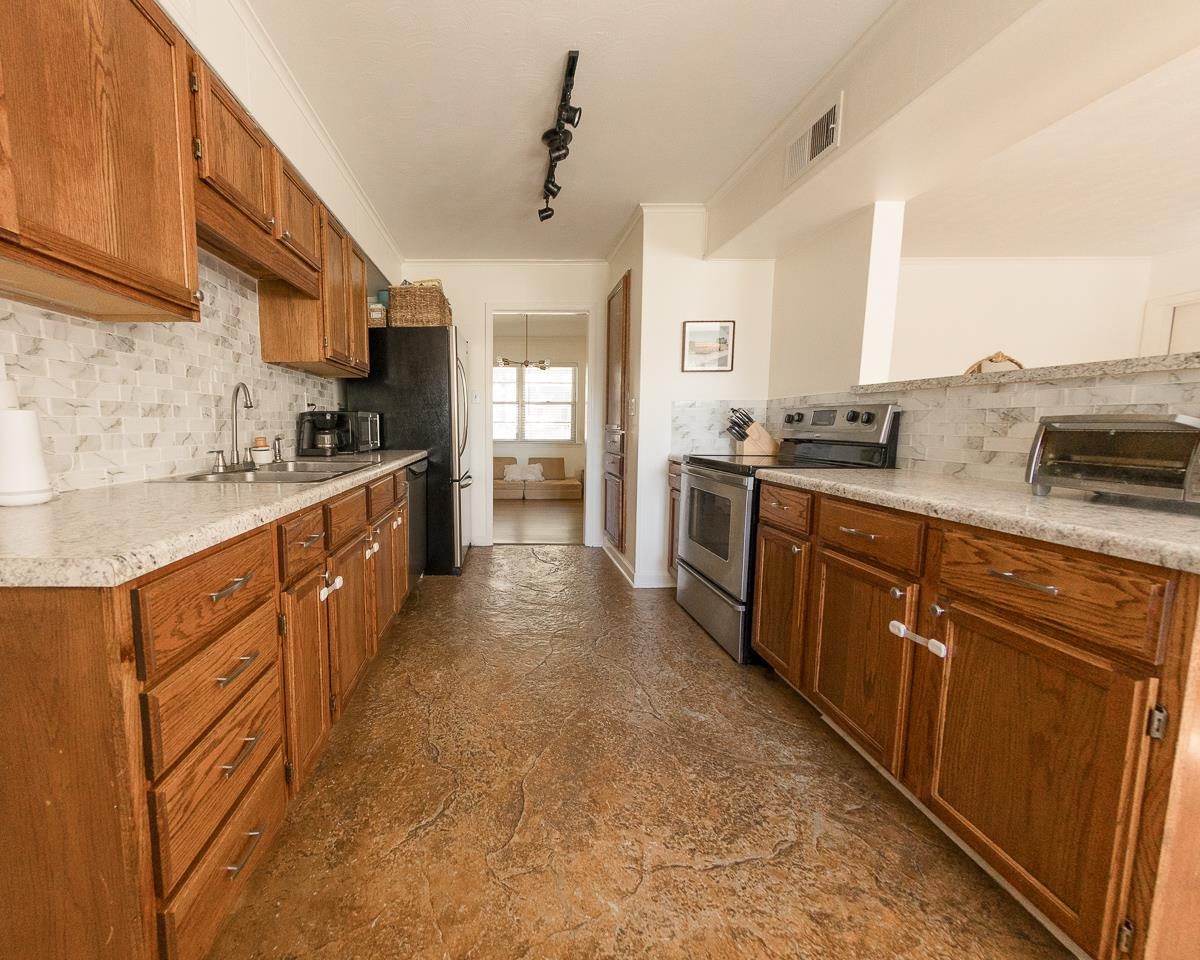 5431 Quince Road Memphis, TN 38119 - Photo 9 of 21 a large kitchen with stainless steel appliances granite countertop a sink stove and refrigerator