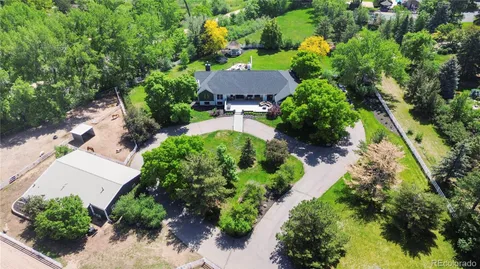 an aerial view of a red and white house with a yard and garden