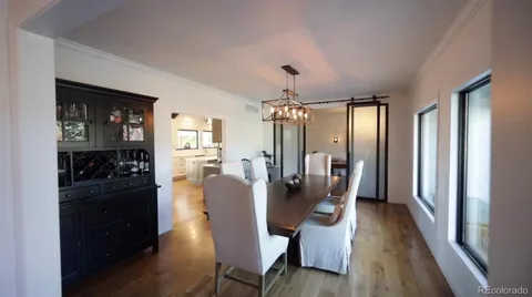 a view of a workspace with furniture and wooden floor