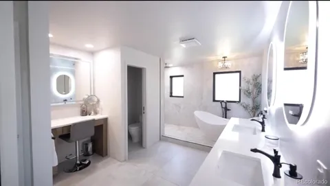 a en suite bathroom with a double vanity sinks and a mirror