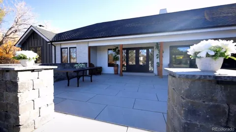a dining room with furniture and a potted plant