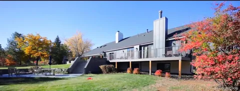 a view of a porch with furniture and garden