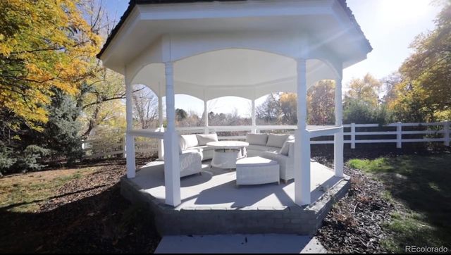 a view of a patio with a table and chairs