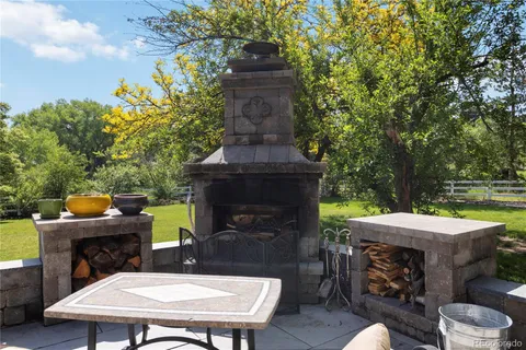 a view of a patio with table and chairs and potted plants