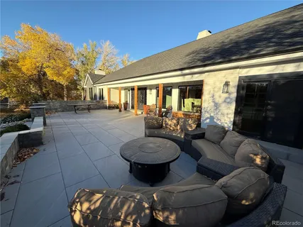 a view of a patio with couches chairs and a potted plant