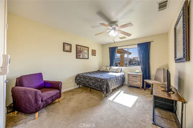 a bedroom with a bed couch and a window