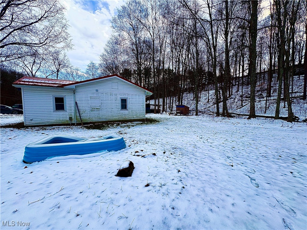 4542 Bloomfield Road Cambridge, OH 43725 - Photo 5 of 22 View of snow covered exterior featuring a metal roof