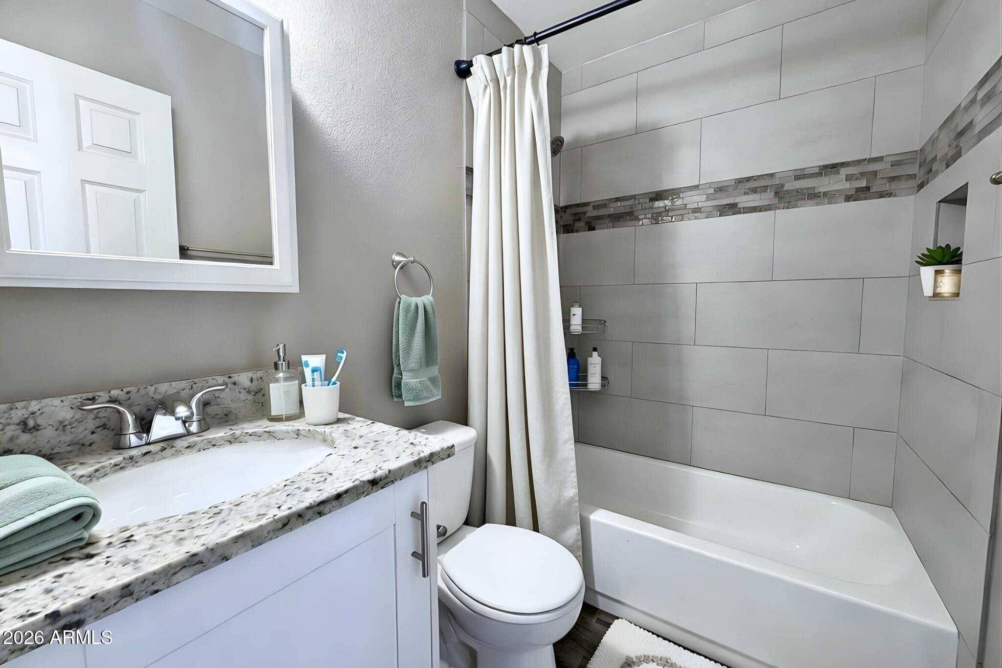 550 West 9th Street, Unit 2 Mesa, AZ 85201 - Photo 9 of 10 a bathroom with a granite countertop sink toilet and shower