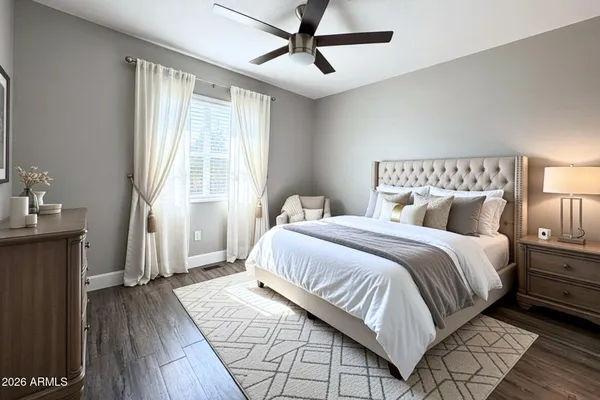 a bedroom with a bed and wooden floor