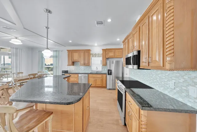 a living room with furniture a flat screen tv and a large window