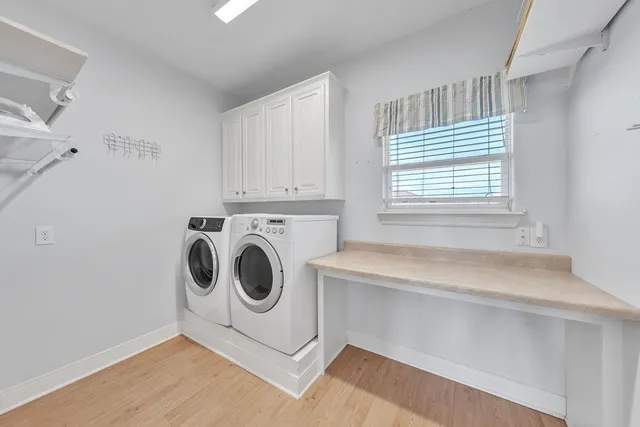 a view of a livingroom with wooden floor and windows