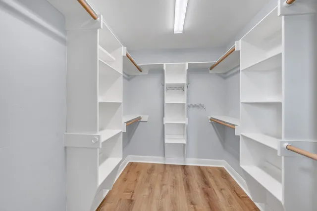 a spacious bathroom with double vanity a mirror a bathtub and shower