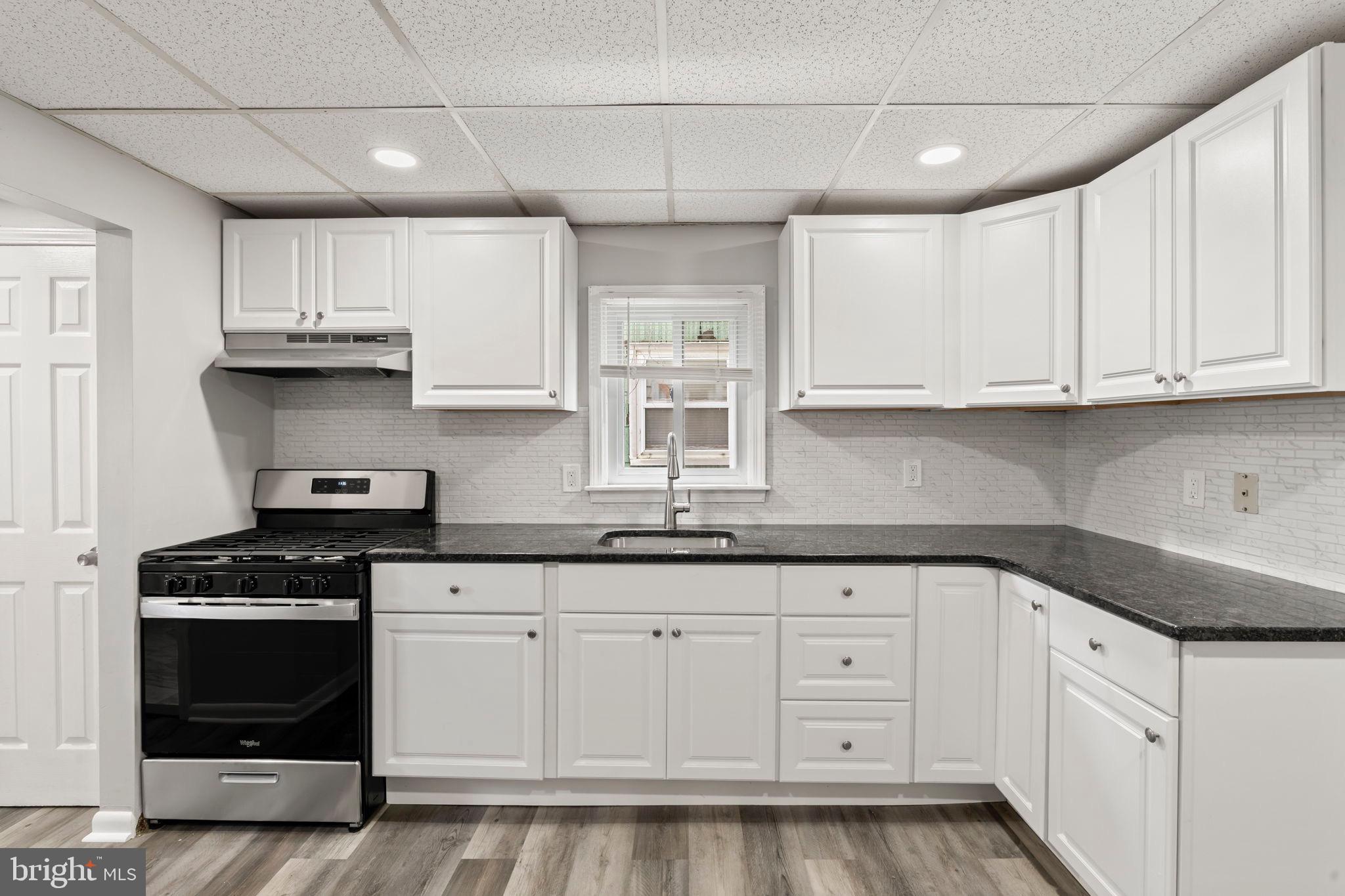 1363 Green Street Marcus Hook, PA 19061 - Photo 11 of 26 a kitchen with granite countertop white cabinets and stainless steel appliances
