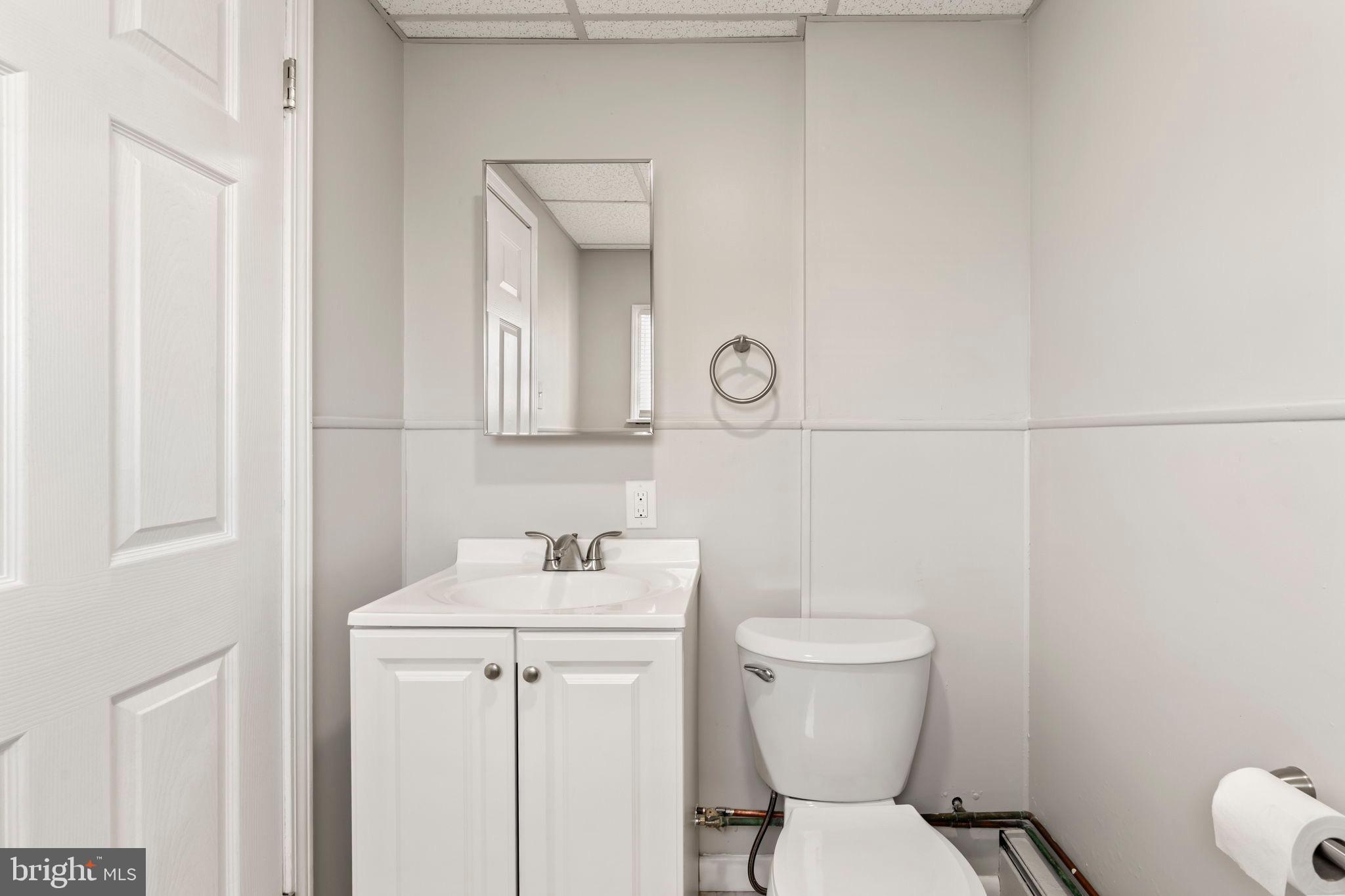 1363 Green Street Marcus Hook, PA 19061 - Photo 14 of 26 a bathroom with a toilet a sink and mirror