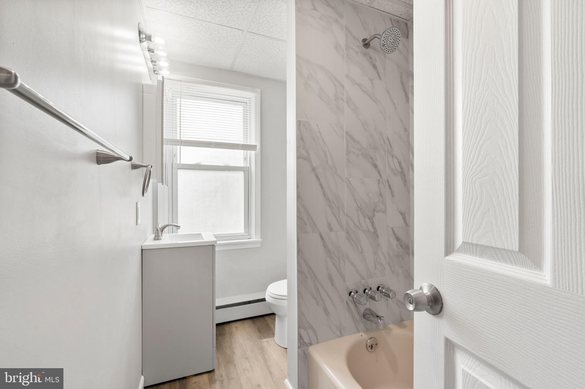 1363 Green Street Marcus Hook, PA 19061 - Photo 21 of 26 a bathroom with a sink a window and tub