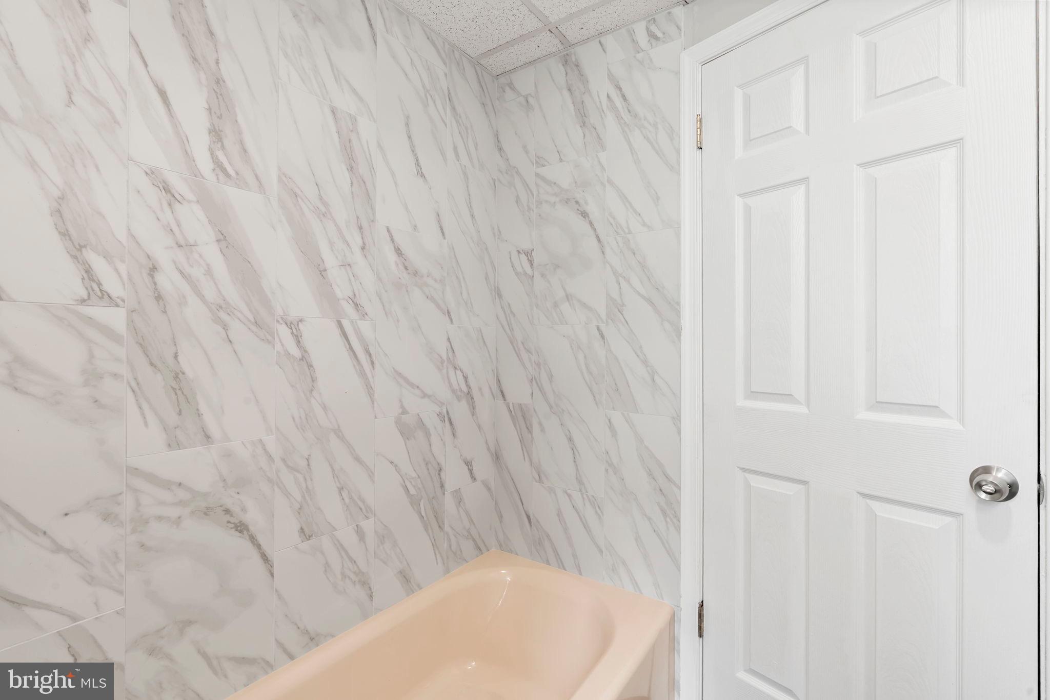 1363 Green Street Marcus Hook, PA 19061 - Photo 23 of 26 a bathroom with a white tub