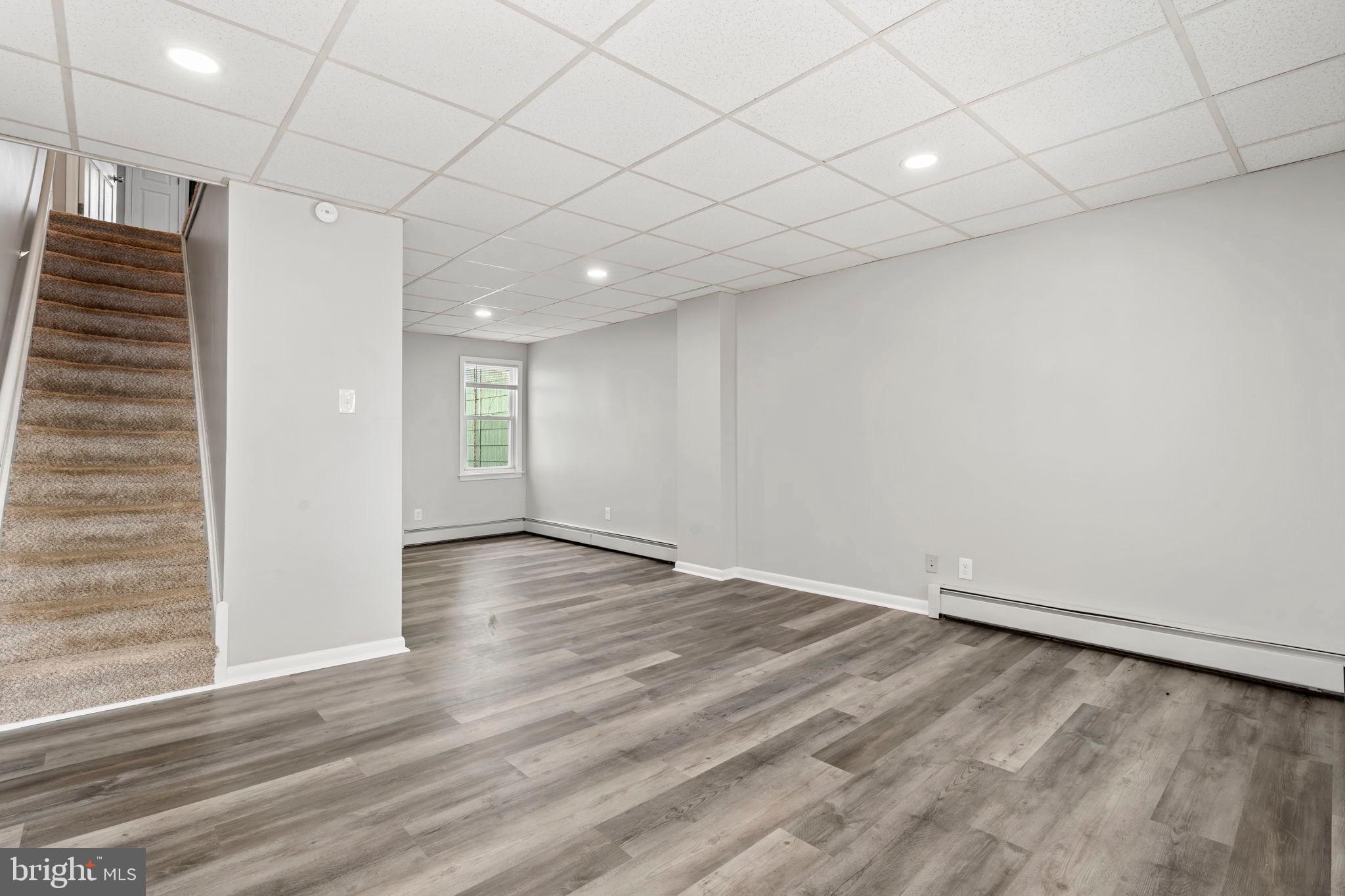 1363 Green Street Marcus Hook, PA 19061 - Photo 6 of 26 an empty room with wooden floor and windows