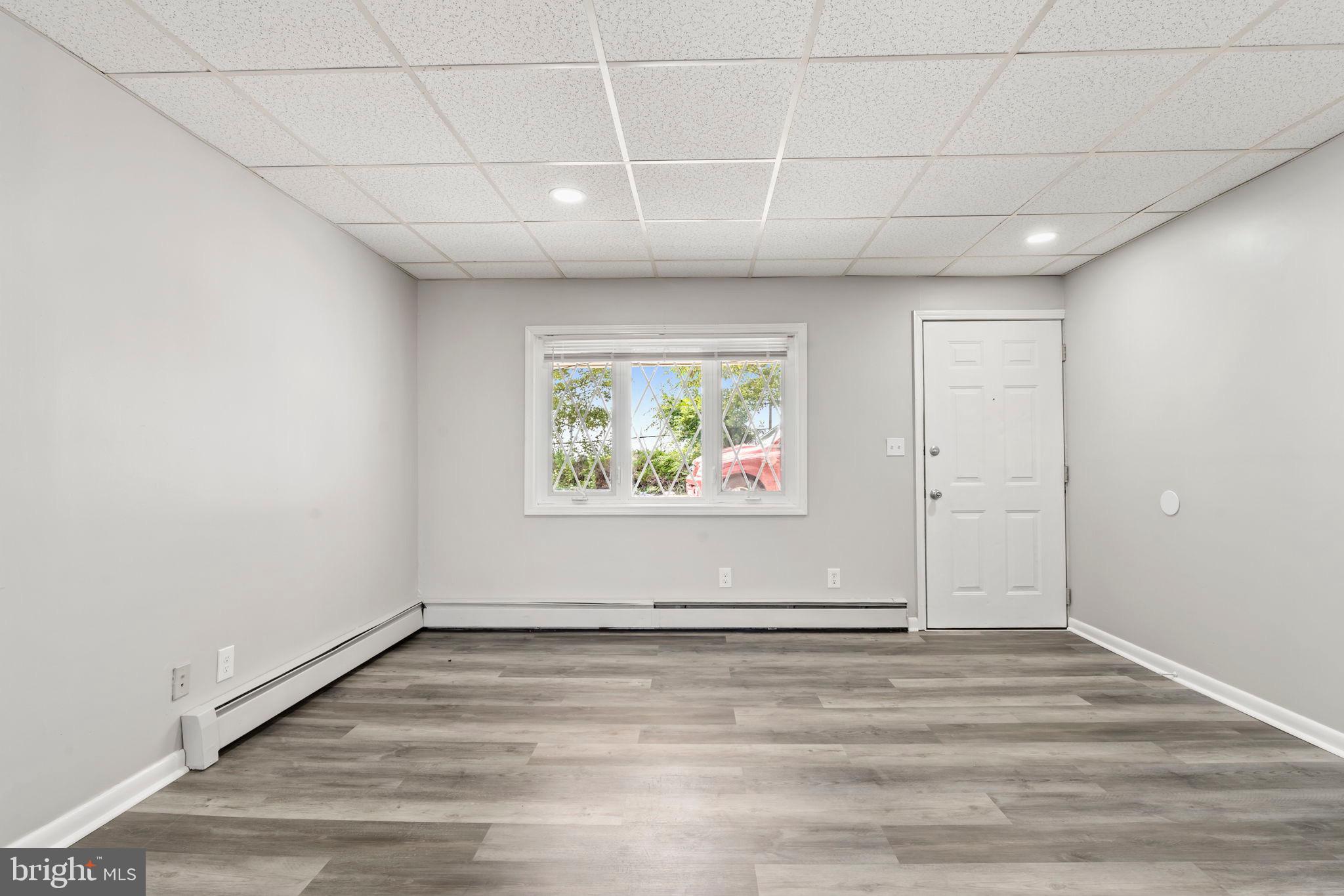 1363 Green Street Marcus Hook, PA 19061 - Photo 7 of 26 an empty room with wooden floor and window