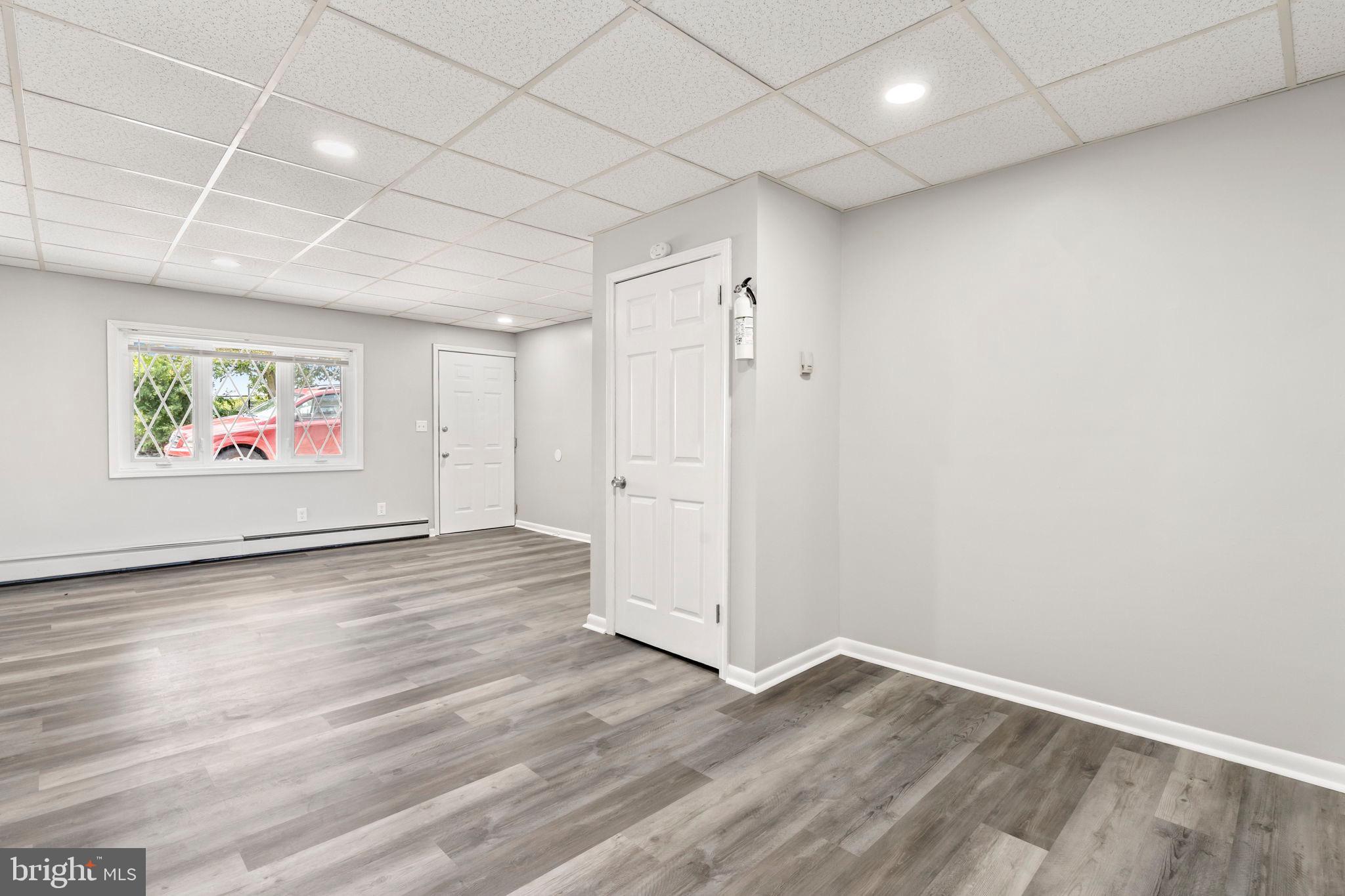 1363 Green Street Marcus Hook, PA 19061 - Photo 8 of 26 an empty room with wooden floor ceiling fan and windows