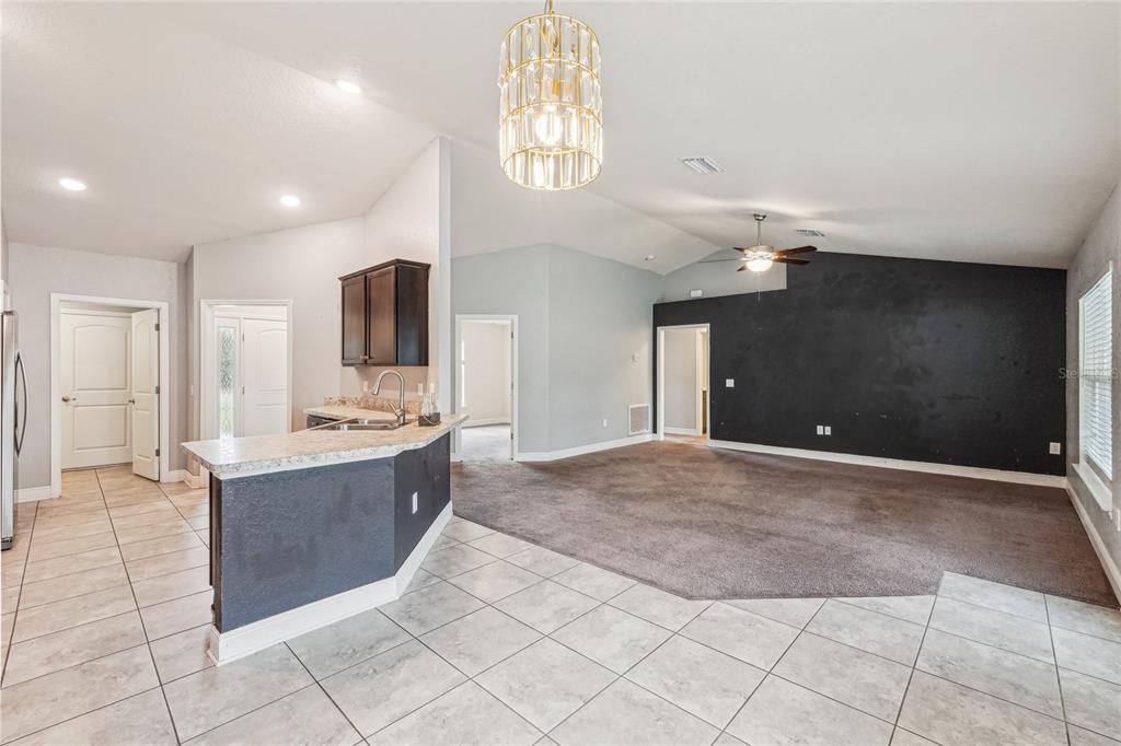 5134 Jenson Avenue Spring Hill, FL 34608 - Photo 11 of 49 a large kitchen with kitchen island granite countertop a sink and a stove top oven