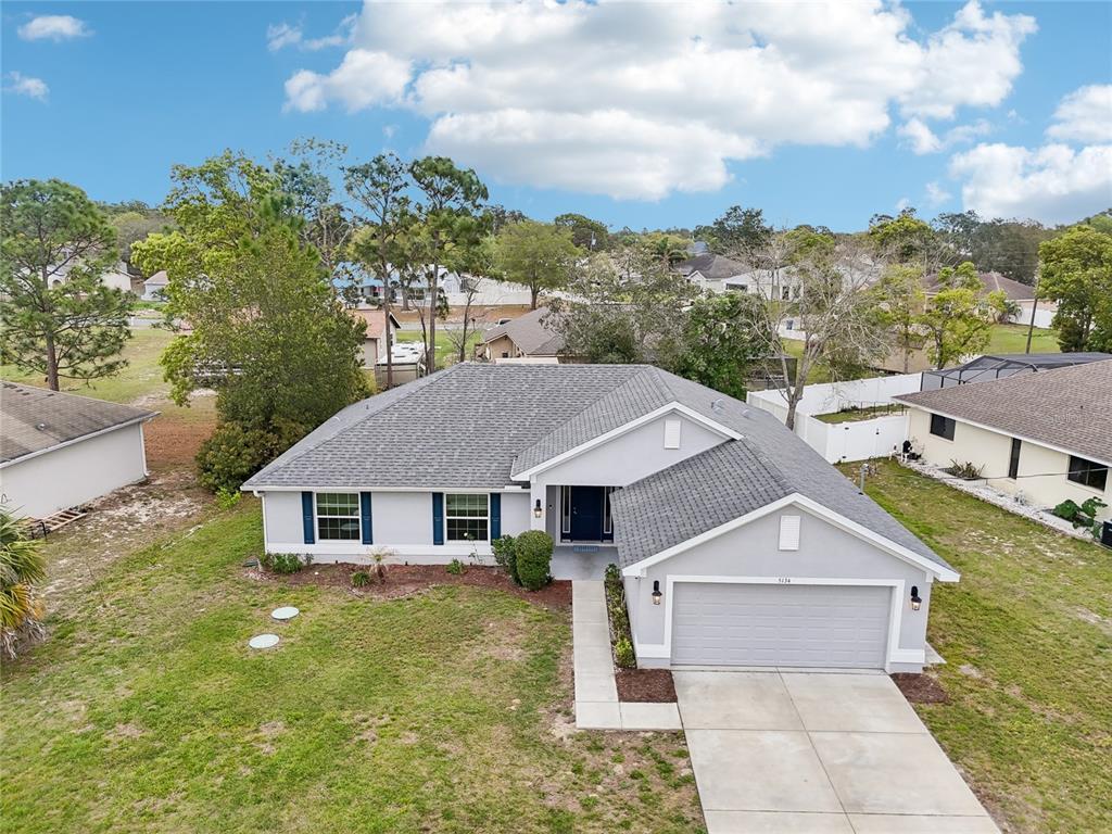 5134 Jenson Avenue Spring Hill, FL 34608 - Photo 38 of 49 a aerial view of a house with a yard table and chairs