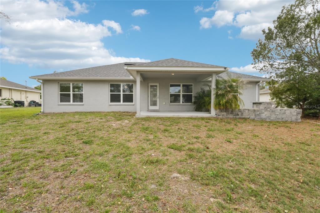 5134 Jenson Avenue Spring Hill, FL 34608 - Photo 6 of 49 a front view of a house with garden