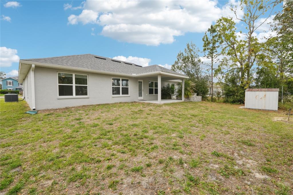 5134 Jenson Avenue Spring Hill, FL 34608 - Photo 7 of 49 a front view of a house with a garden