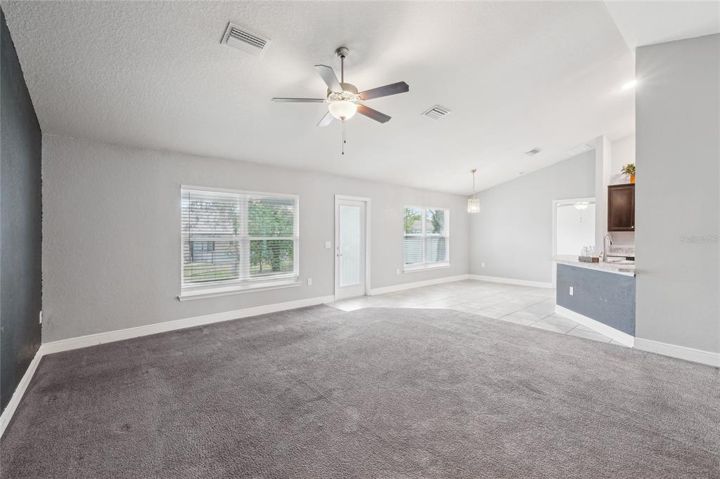 5134 Jenson Avenue Spring Hill, FL 34608 - Photo 10 of 49 a view of a livingroom with a ceiling fan and window