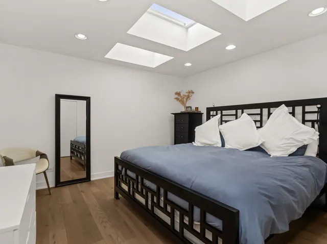 a bed room with a bed and a night stand