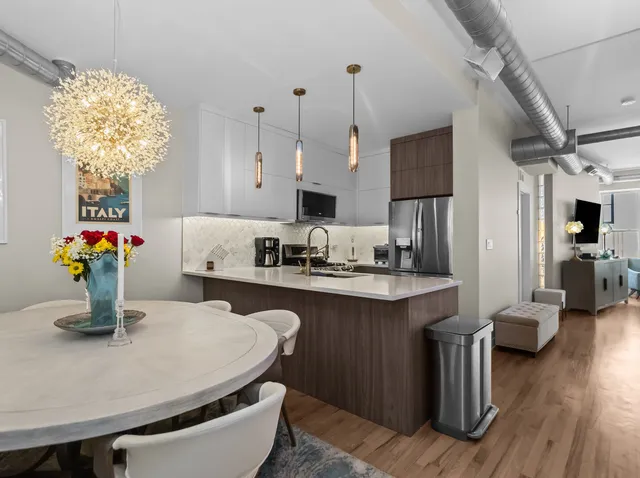 a kitchen with sink refrigerator and cabinets