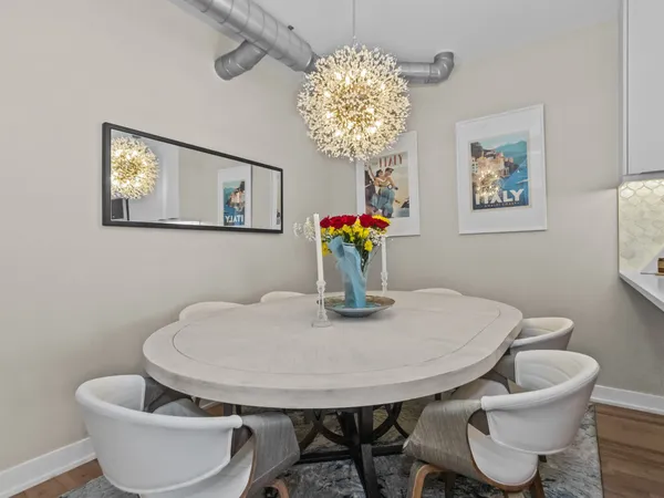 a dining room with furniture and chandelier