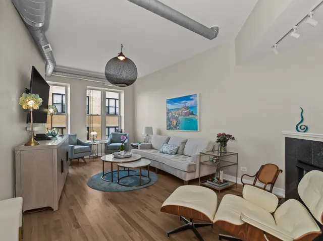 a living room with furniture a chandelier a rug and a window