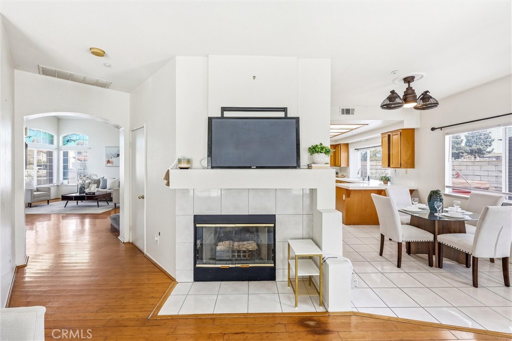 11453 Plane Tree Road Fontana, CA 92337 - Photo 21 of 40 a living room with furniture a fireplace and a flat screen tv