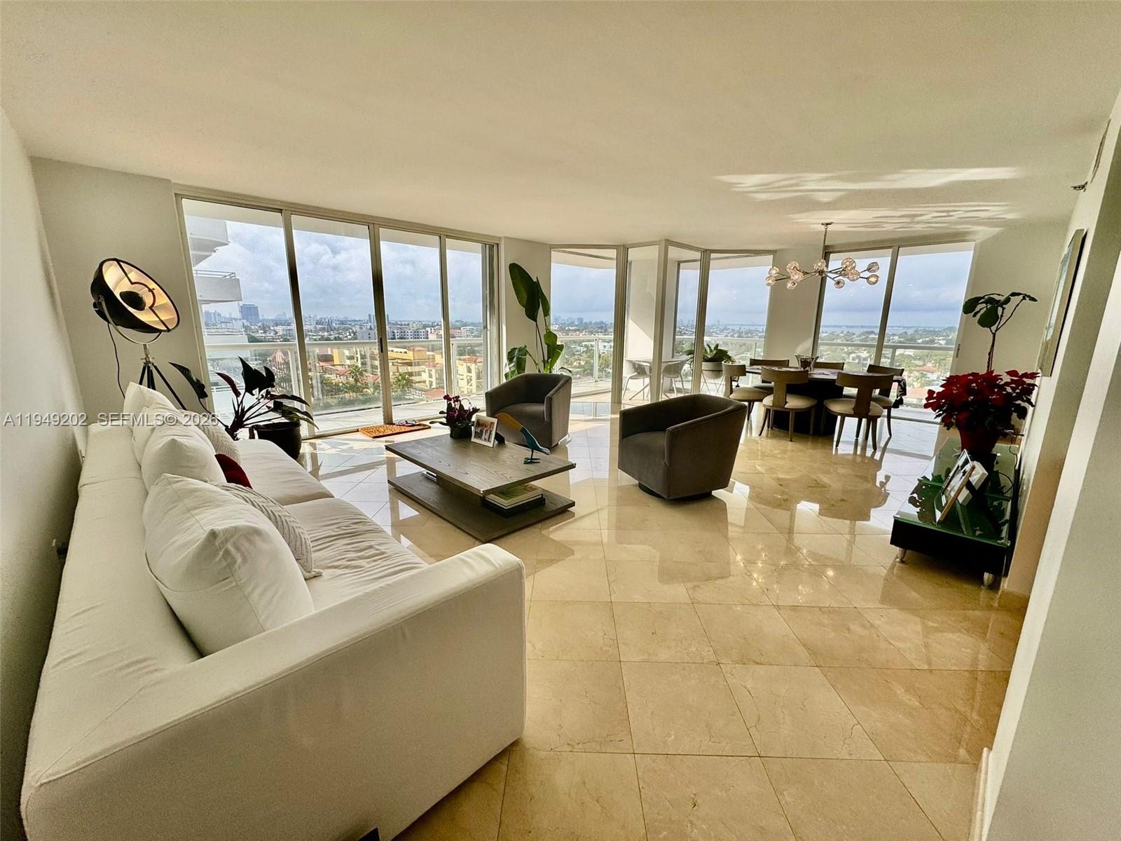 8925 Collins Avenue, Unit 9G Surfside, FL 33154 - Photo 2 of 17 a living room with furniture and floor to ceiling window