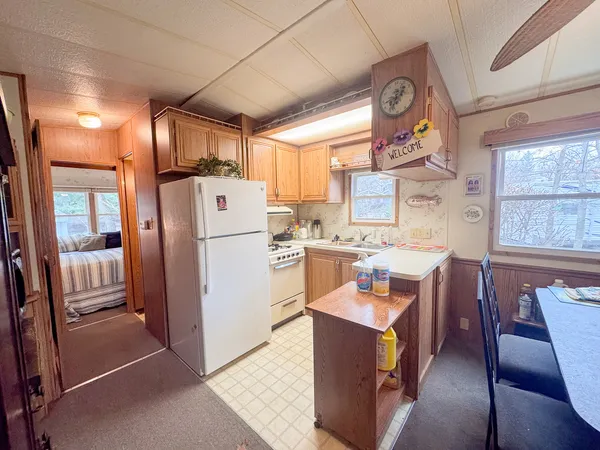 a kitchen with stainless steel appliances granite countertop a refrigerator and a stove top oven