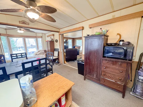 a living room with furniture and a dining table
