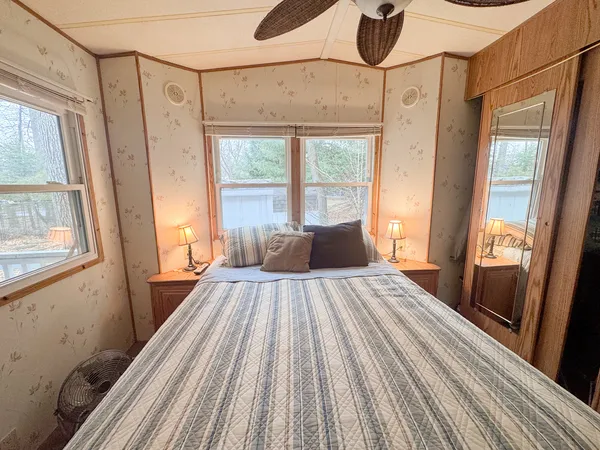 a view of a bedroom with wooden floor and balcony