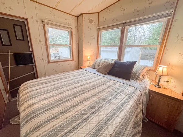 a bedroom with a bed and a window