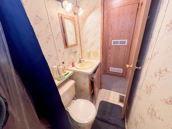 a white toilet sitting next to a small sink