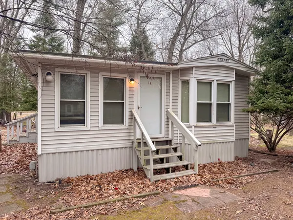 a view of a house with a yard and wooden fence