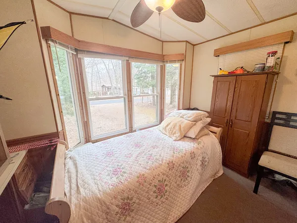 a bedroom with a bed next to a window