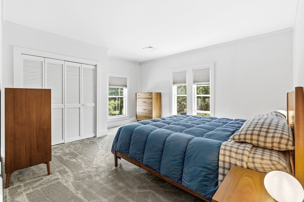 58 Front Street Northampton, MA 01053 - Photo 22 of 42 a bedroom with a bed and dresser with wooden floor
