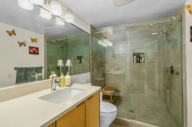 a bathroom with a sink toilet and shower