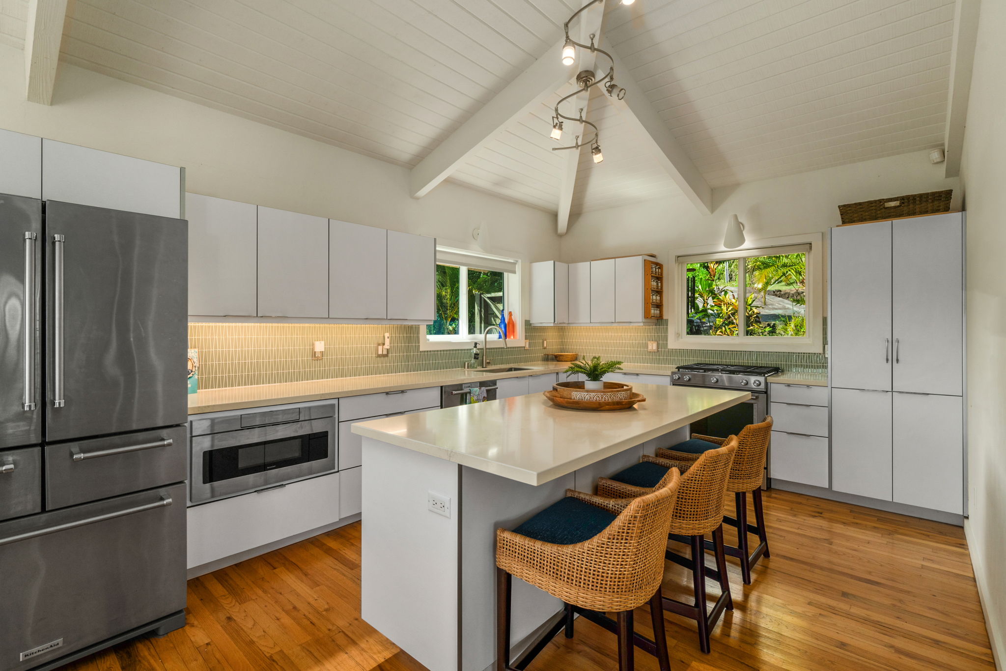 3707 Omao Road Koloa, HI 96756 - Photo 5 of 27 a kitchen with a table chairs refrigerator and cabinets