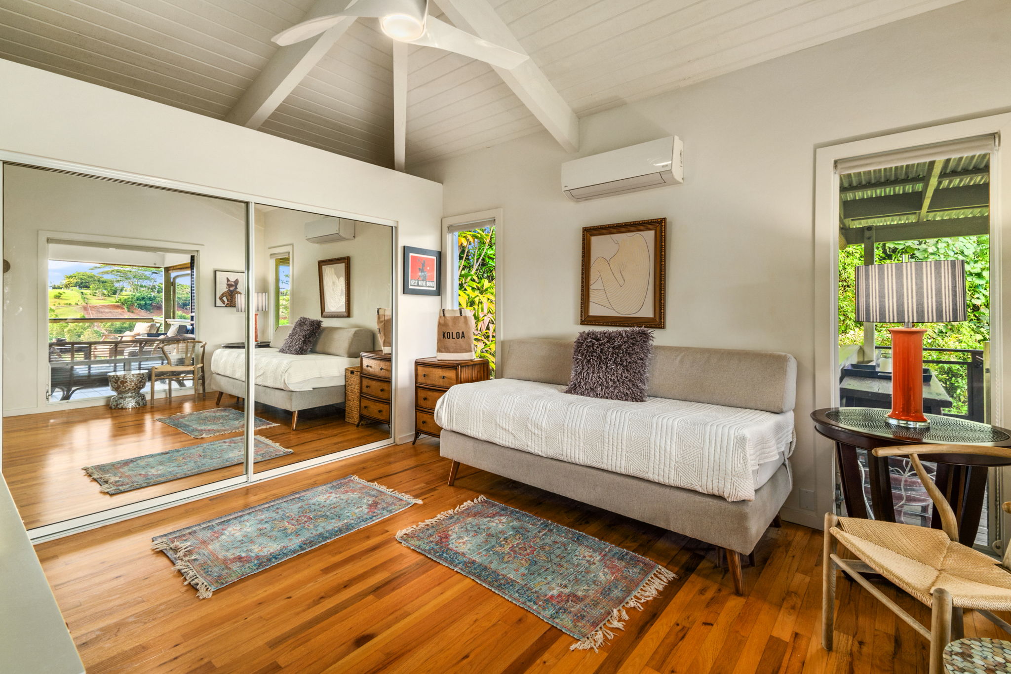 3707 Omao Road Koloa, HI 96756 - Photo 10 of 27 a bedroom with a bed and wooden floor