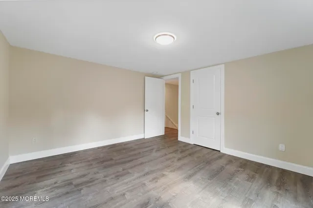 a view of a room with wooden floor and window