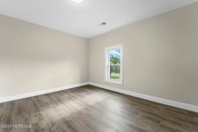 an empty room with wooden floor